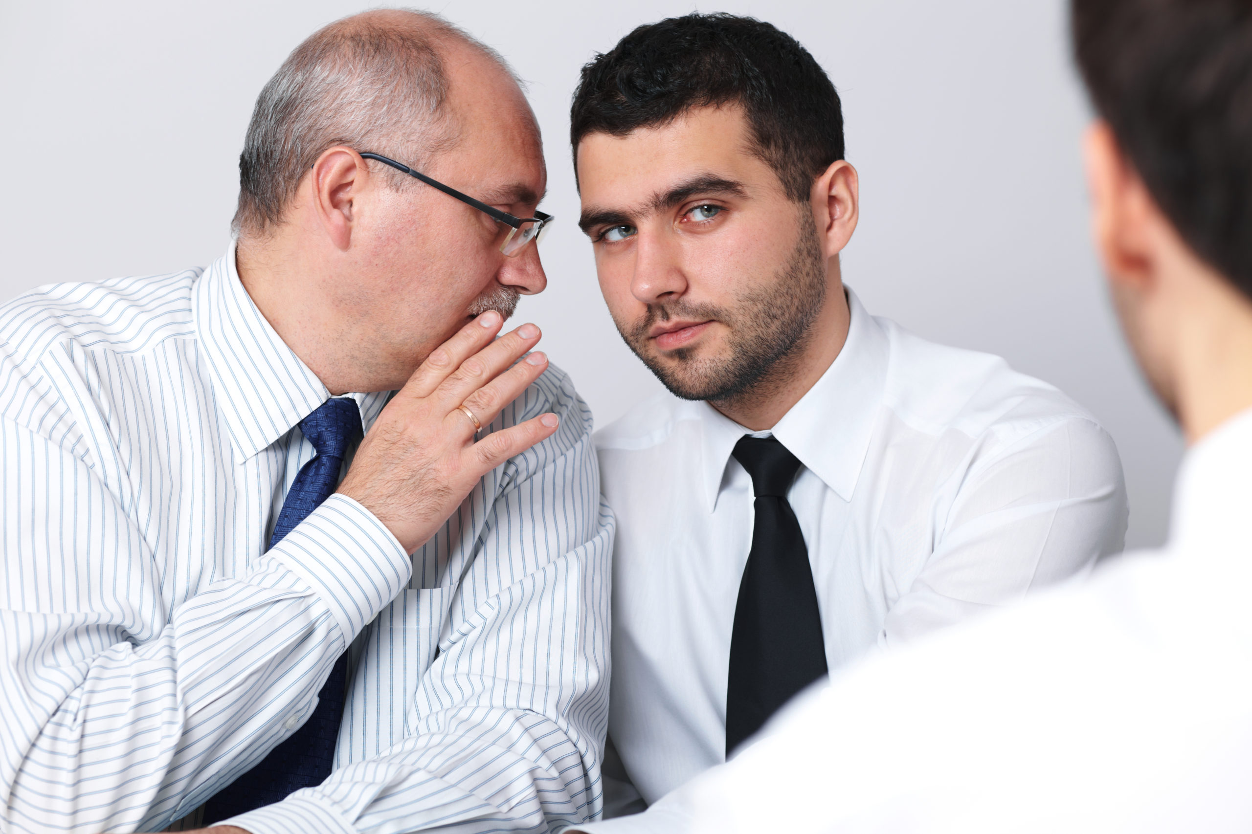 Man whispering to a man while filing personal injury claim in Florida